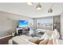 Inviting living room with modern decor, large windows showcasing bay views and an open layout at 4725 Cove Cir # 604, St Petersburg, FL 33708