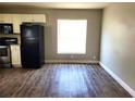 Spacious open-concept kitchen area with black appliances and wood-look flooring at 4801 Haines N Rd, St Petersburg, FL 33714