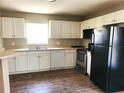 Functional kitchen featuring white cabinets, stainless steel appliances, and ample countertop space at 4801 Haines N Rd, St Petersburg, FL 33714