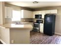Functional kitchen featuring white cabinets, stainless steel appliances, and ample countertop space at 4801 Haines N Rd, St Petersburg, FL 33714