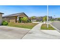 A neighborhood street featuring sidewalks, street lamps and similarly styled homes at 5457 Leslie Canyon Dr, Wimauma, FL 33598