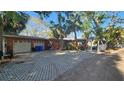 Charming home with a two-car garage and patterned driveway at 6 Sea S Ln, St Petersburg, FL 33705