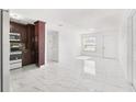 Bright living room showcasing tile floors and a neutral color palette at 6010 Blossom Ave, Tampa, FL 33614