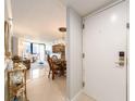 Inviting condo foyer leads to a combined dining and living area with beautiful tile floors at 690 Island Way # 1011, Clearwater Beach, FL 33767