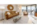 Inviting living room showcases stylish decor, comfortable sofa and balcony access at 690 Island Way # 1011, Clearwater Beach, FL 33767