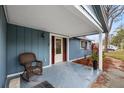 Inviting covered front porch with rocking chair and charming entrance detail at 7247 Oelsner St, New Port Richey, FL 34652