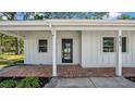 Charming facade featuring a brick entryway, and a modern black door with glass panels at 8262 26Th N Ave, St Petersburg, FL 33710