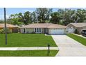 Inviting single-story home with a lush green lawn and convenient driveway at 9155 125Th St, Seminole, FL 33772
