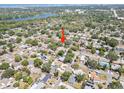 Aerial view showcasing the home's location within a lush, established neighborhood near a lake and cityscape at 920 16Th Sw Ave, Largo, FL 33770