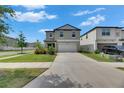 Attractive two-story home featuring a well-maintained lawn, concrete driveway, and lush landscaping at 9907 Spanish Lime Ct, Riverview, FL 33578