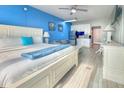 Charming studio condo featuring stylish decor, bright blue accent wall, and all white furniture at 9980 Gulf Blvd # 603, Treasure Island, FL 33706