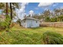 Expansive backyard featuring lush green grass and a charming, light blue home at 1045 22Nd N Ave, St Petersburg, FL 33704