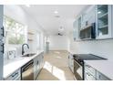 Modern kitchen featuring stainless steel appliances, quartz countertops, and blue cabinets at 1045 22Nd N Ave, St Petersburg, FL 33704