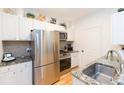 Modern kitchen featuring stainless steel appliances, granite countertops, and ample cabinet space at 10473 Villa View Cir, Tampa, FL 33647