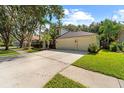 Beautiful home featuring an attached three-car garage, a spacious driveway, and a well-manicured lawn at 1133 Split Silk St, Valrico, FL 33594