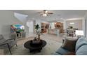 Open-concept living area with kitchen, dining, and a staircase featuring neutral colors and stylish decor at 12150 Ledbury Commons Dr, Gibsonton, FL 33534