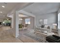 Bright living room with open floor plan, modern furnishings, and decorative area rug at 12150 Ledbury Commons Dr, Gibsonton, FL 33534