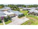 Aerial view of home, showcasing the roof, long driveway, and surrounding community at 1339 Queen Anne Dr # C, Palm Harbor, FL 34684