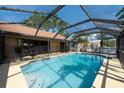 Backyard swimming pool with a screened enclosure for outdoor relaxation at 1615 Loghill Pl, Brandon, FL 33510