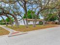 Inviting single-story home with lush landscaping and mature trees in a quiet neighborhood at 1700 25Th N St, St Petersburg, FL 33713