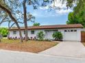 Attractive single-story house featuring a pristine white exterior, beautiful landscaping and a one-car garage at 1700 25Th N St, St Petersburg, FL 33713