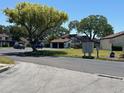 Charming neighborhood street with mature trees, manicured lawns, and inviting homes with community mailboxes at 2055 Sunset Point Rd # 3804, Clearwater, FL 33765