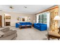 Bright and spacious living room featuring large windows, plush sofas, and neutral carpeting at 2072 Maguire Ave, Spring Hill, FL 34608
