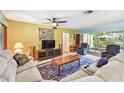Comfortable living room with ample seating, ceiling fan, and sliding glass doors to the outdoor patio at 220 22Nd Se Ave, St Petersburg, FL 33705