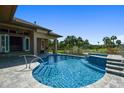 Backyard pool with lush landscaping and scenic golf course views at 2605 59Th S St, Gulfport, FL 33707