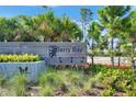 Berry Bay community entrance sign surrounded by lush tropical landscaping and vibrant plants at 2805 Gumbo Limbo Dr, Wimauma, FL 33598