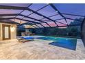 Private pool with fountains, stone fireplace, and screened enclosure offering serene outdoor living at 3100 Barbour Trl, Odessa, FL 33556