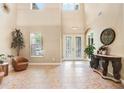 Spacious foyer with high ceilings, tiled floors, and decorative furniture creating a grand entrance at 3243 Watermark Dr, Wesley Chapel, FL 33544