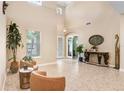 Inviting foyer with soaring ceilings, tile floors, and tastefully placed furnishings, perfect for welcoming guests at 3243 Watermark Dr, Wesley Chapel, FL 33544