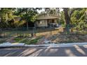 Charming home with a chain-link fence and mature trees in the front yard, offering potential and curb appeal at 3611 W Reynolds St # 1/2, Plant City, FL 33563