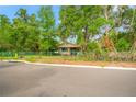 Street view of a cozy home with mature trees and a well-maintained lawn at 3611 W Reynolds St # 1/2, Plant City, FL 33563
