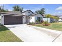 Beautiful single-story home with a well-manicured front lawn and spacious driveway at 36568 Garden Wall Way, Zephyrhills, FL 33541
