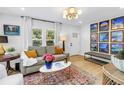 Inviting living room filled with natural light, featuring a cozy sofa, stylish decor, and a colorful rug at 420 S Matanzas Ave, Tampa, FL 33609