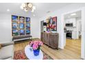 Open-concept living area with a modern cabinet, stylish decor, and view into the kitchen at 420 S Matanzas Ave, Tampa, FL 33609