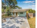 Charming single-story home with a covered carport and a well-maintained front yard at 4901 Venetian Ne Blvd, St Petersburg, FL 33703