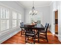 Bright dining room featuring hardwood floors, natural light, and stylish chandelier at 5804 N 9Th St, Tampa, FL 33604