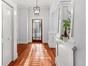 Elegant entryway with hardwood floors, white trim, and a stylish light fixture at 5804 N 9Th St, Tampa, FL 33604