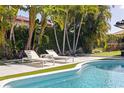 Relaxing poolside view with comfortable lounge chairs and lush greenery offering a private outdoor retreat at 7108 Pelican Island Dr, Tampa, FL 33634