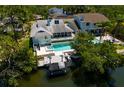Aerial view of the backyard, pool, jacuzzi, boat lift and waterfront of the house at 733 Captiva Ne Ct, St Petersburg, FL 33702