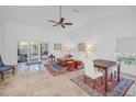 Bright living room featuring high ceilings, tile floors, and large sliding doors to the lanai at 826 Glades Ne Ct, St Petersburg, FL 33702