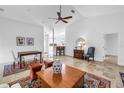 Open living space with tile floors, a ceiling fan, and views into the kitchen at 826 Glades Ne Ct, St Petersburg, FL 33702