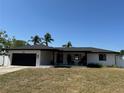 Inviting single-story house with a black garage door and a cozy front porch at 926 Eagle Ln, Apollo Beach, FL 33572