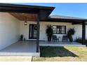 Stylish front porch with decorative tiles, comfortable seating, and a welcoming entrance at 926 Eagle Ln, Apollo Beach, FL 33572