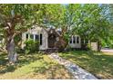 Inviting home with a charming front entrance, surrounded by mature, lush trees and grass at 101 22Nd N Ave, St Petersburg, FL 33704