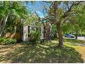 Quaint home with mature trees, landscaping, a brick chimney and well-kept lawn at 101 22Nd N Ave, St Petersburg, FL 33704