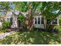 Charming home with a brick chimney, cozy front entrance, and beautiful mature landscaping at 101 22Nd N Ave, St Petersburg, FL 33704